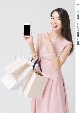 Happy single woman life, an attractive smiling woman holding shopping bags 423 Happy single woman life, an attractive smiling woman holding shopping bags 423 60700981