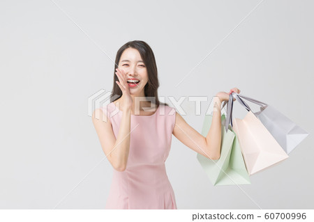 Happy single woman life, an attractive smiling woman holding shopping bags 280 Happy single woman life, an attractive smiling woman holding shopping bags 280 60700996