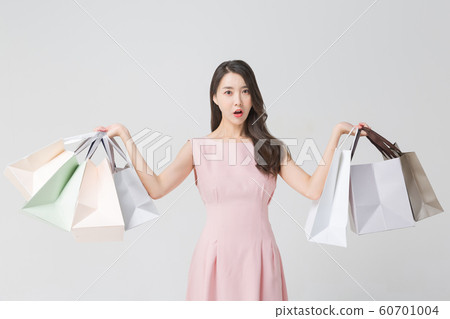 Happy single woman life, an attractive smiling woman holding shopping bags 404 Happy single woman life, an attractive smiling woman holding shopping bags 404 60701004