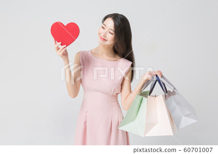 Happy single woman life, an attractive smiling woman holding shopping bags 302 Happy single woman life, an attractive smiling woman holding shopping bags 302 60701007