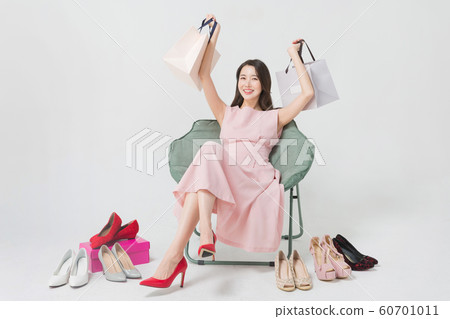 Happy single woman life, an attractive smiling woman holding shopping bags 292 Happy single woman life, an attractive smiling woman holding shopping bags 292 60701011