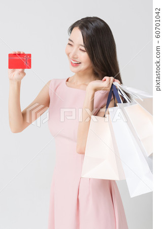 Happy single woman life, an attractive smiling woman holding shopping bags 364 Happy single woman life, an attractive smiling woman holding shopping bags 364 60701042
