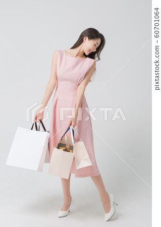 Happy single woman life, an attractive smiling woman holding shopping bags 346 60701064
