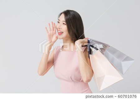 Happy single woman life, an attractive smiling woman holding shopping bags 326 Happy single woman life, an attractive smiling woman holding shopping bags 326 60701076