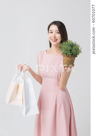 Happy single woman life, an attractive smiling woman holding shopping bags 319 Happy single woman life, an attractive smiling woman holding shopping bags 319 60701077