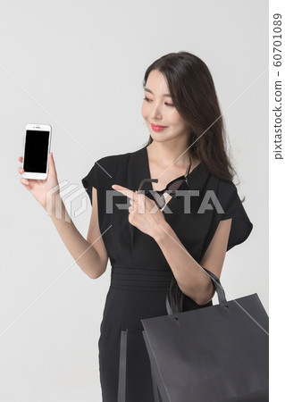 Happy single woman life, an attractive smiling woman holding shopping bags 118 Happy single woman life, an attractive smiling woman holding shopping bags 118 60701089