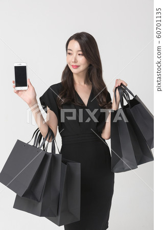 Happy single woman life, an attractive smiling woman holding shopping bags 088 Happy single woman life, an attractive smiling woman holding shopping bags 088 60701135