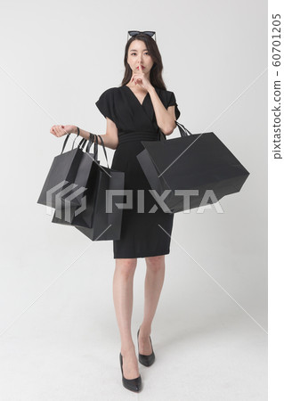 Happy single woman life, an attractive smiling woman holding shopping bags 102 Happy single woman life, an attractive smiling woman holding shopping bags 102 60701205