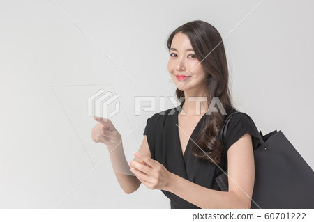 Happy single woman life, an attractive smiling woman holding shopping bags 101 60701222
