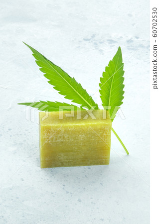 Cannabis soap bar with a fresh cannabis leaf and copy space Cannabis soap bar with a fresh cannabis leaf and copy space 60702530
