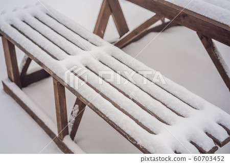 Benches in the winter city park which has been filled up with snow 60703452