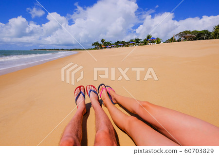 The beautiful naked legs of a couple wearing flip flops on the sandy beach Praia Do Mutari Brava, Porto Seguro, Brazil The beautiful naked legs of a couple wearing flip flops on the sandy beach Praia Do Mutari Brava, Porto Seguro, Brazil 60703829