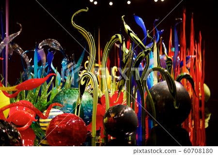 SEATTLE, WASHINGTON, USA - JAN 23rd, 2017: Blown glass in abstract shapes of flowers in red and yellow, Exhibit by American Artist Dale Chihuly at Chihuly Garden and Glass Museum SEATTLE, WASHINGTON, USA - JAN 23rd, 2017: Blown glass in abstract shapes of flowers in red and yellow, Exhibit by American Artist Dale Chihuly at Chihuly Garden and Glass Museum 60708180
