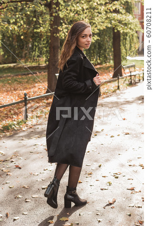Portrait of stylish smiling happy woman walking in street, positive mood, girl enjoy weekends 60708211
