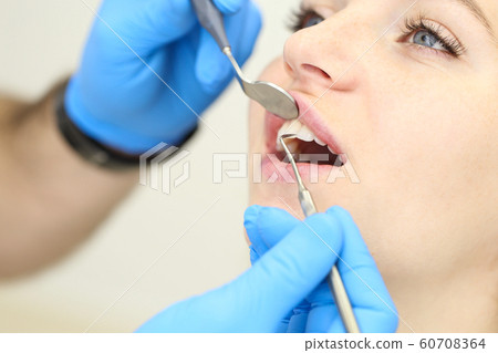 Closeup of beautiful who woman undergo dental procedures. Selective focus 60708364