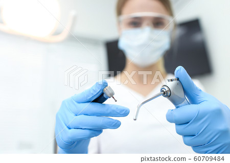Closeup of dental instruments in hands of doctor. Selective focus 60709484