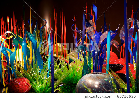 SEATTLE, WASHINGTON, USA - JAN 23rd, 2017: Blown glass in abstract shapes of flowers in red and yellow, Exhibit by American Artist Dale Chihuly at Chihuly Garden and Glass Museum SEATTLE, WASHINGTON, USA - JAN 23rd, 2017: Blown glass in abstract shapes of flowers in red and yellow, Exhibit by American Artist Dale Chihuly at Chihuly Garden and Glass Museum 60710659