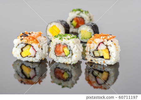 Japanese food sushi rolls uramaki in reflection close-up. 60711197