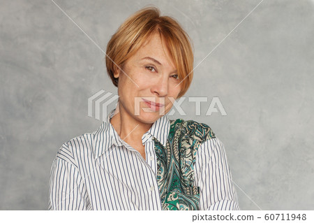 Beautiful middle aged woman with short ginger hair Beautiful middle aged woman with short ginger hair 60711948