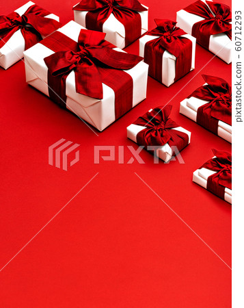 Gift boxes with red ribbon bows. 60712293