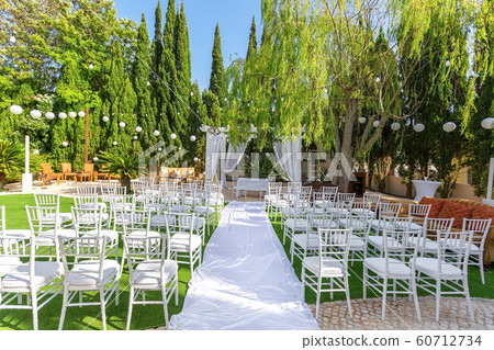Decorations for the wedding ceremony in the garden. With an arch in flowers. Decorations for the wedding ceremony in the garden. With an arch in flowers. 60712734