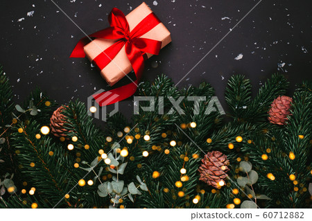 Gift with pine tree branches 60712882