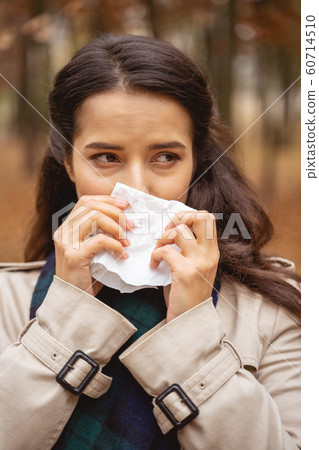 Close up of pleased woman that wiping her nose 60714510