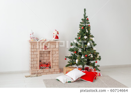 Fireplace and Christmas tree with presents in living room 60714664