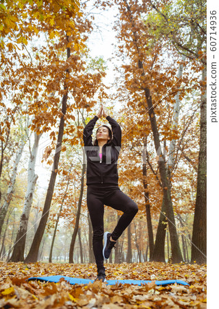Amazing brunette female person standing in yoga pose Amazing brunette female person standing in yoga pose 60714936