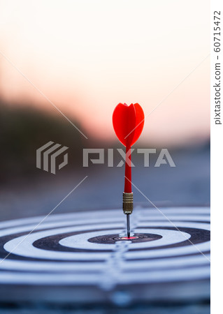 Close up red dart arrow hitting target center Close up red dart arrow hitting target center 60715472