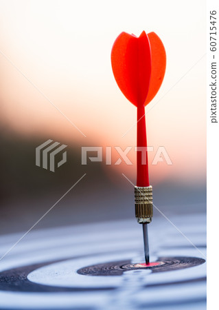 Close up red dart arrow hitting target center Close up red dart arrow hitting target center 60715476