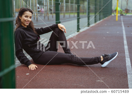 Positive delighted female person having rest after train 60715489