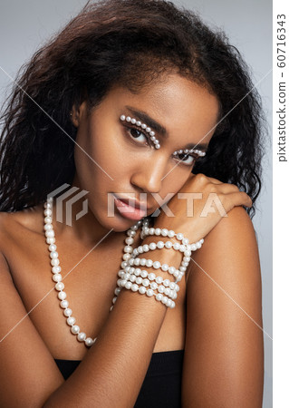 Pretty woman with startling makeup posing for camera Pretty woman with startling makeup posing for camera 60716343