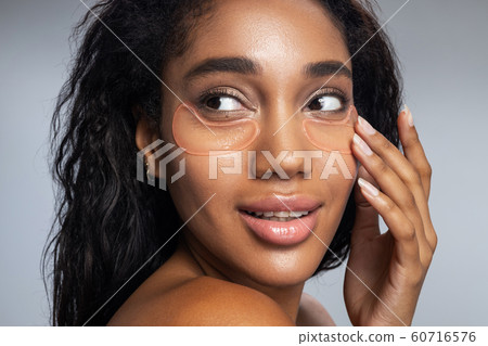 Attractive nice lady with patches on her face posing for camera Attractive nice lady with patches on her face posing for camera 60716576