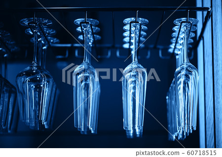 Glasses in a row above bar rack in restaurant Glasses in a row above bar rack in restaurant 60718515