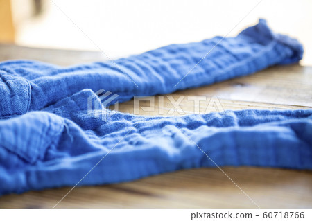 Undressed blue pants on a wooden table Undressed blue pants on a wooden table 60718766