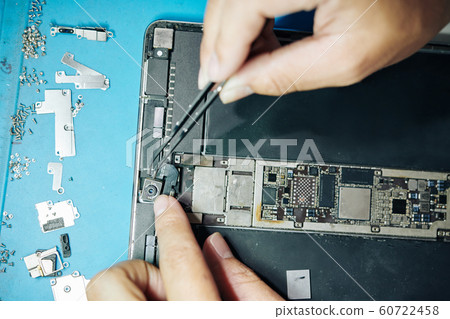 Worker establishing camera in tablet 60722458