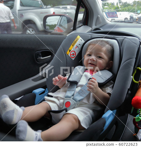 cute baby boy excited sitting on car seat safety drive road trip travel 60722623