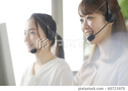 Young woman working at a call center operator Young woman working at a call center operator 60723970