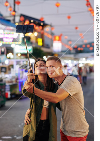 Happy couple taking selfie Happy couple taking selfie 60726797