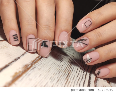 Gray striped nail design on female hand close up. 60728059