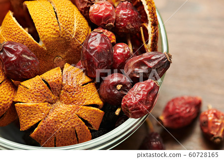 dry dogrose and tangerine in a vase on wooden dry dogrose and tangerine in a vase on wooden 60728165