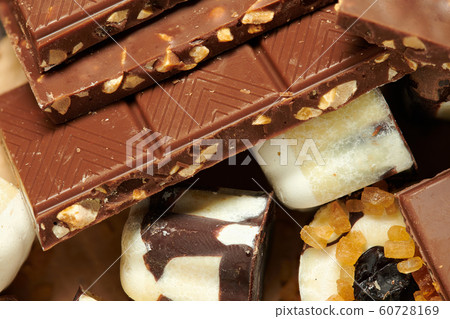 Chocolate bars and homemade candies on rustic Chocolate bars and homemade candies on rustic 60728169
