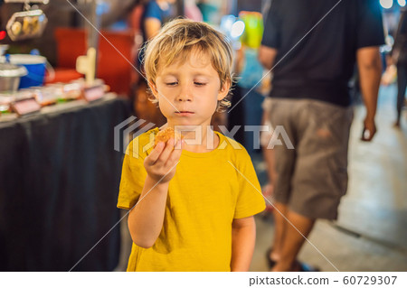 Boy tourist on Walking street Asian food market Boy tourist on Walking street Asian food market 60729307