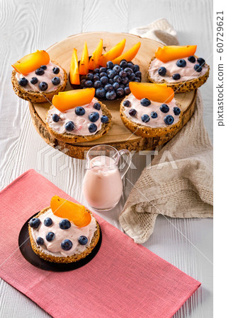 Buns with soft cheese, blueberry and persimmon 60729621