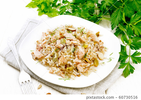 Salad of salmon and rice in plate on wooden board Salad of salmon and rice in plate on wooden board 60730516
