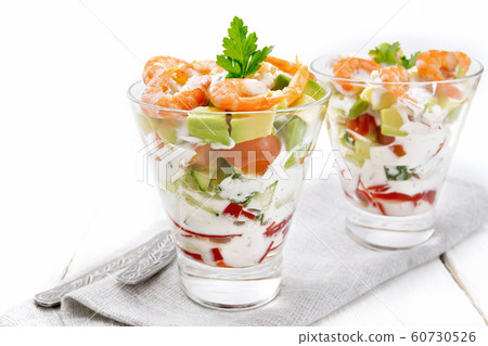 Salad with shrimp and avocado in glasses on table Salad with shrimp and avocado in glasses on table 60730526