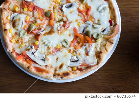 Close up Italian pizza with olives, tomatoes 60730574