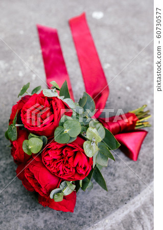 Wedding bouquet with red roses on the table Wedding bouquet with red roses on the table 60730577