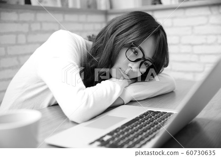 Tired glasses woman with computer at home 60730635